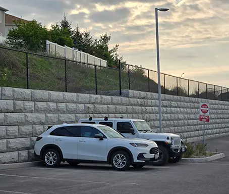 A couple of white cars parked next to each other.