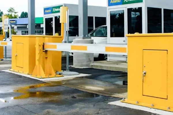 A car is parked in front of the entrance to a gas station.